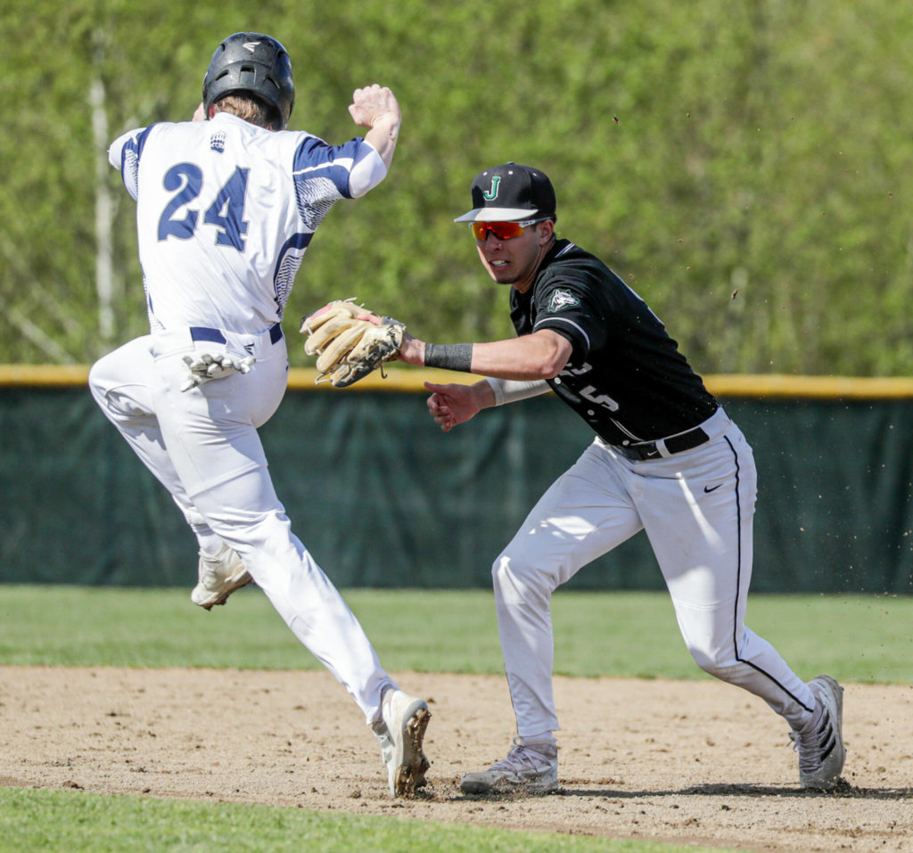 Jackson’s Bryan Ho beats a throw to Glacier Peak’s Colby Holmdahl Friday afternoon at Glacier Peak High School in Snohomish, Washington on April 22, 2022. The Timberwolves won 12-4. (Kevin Clark / The Herald)
