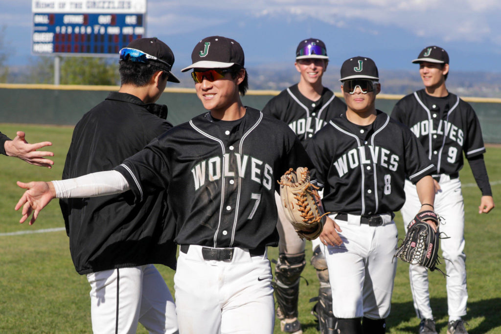 Jackson’s Ryan Nakajima, 7, leads the way to the dugout during a change over Friday afternoon at Glacier Peak High School in Snohomish, Washington on April 22, 2022. The Timberwolves won 12-4. (Kevin Clark / The Herald)
