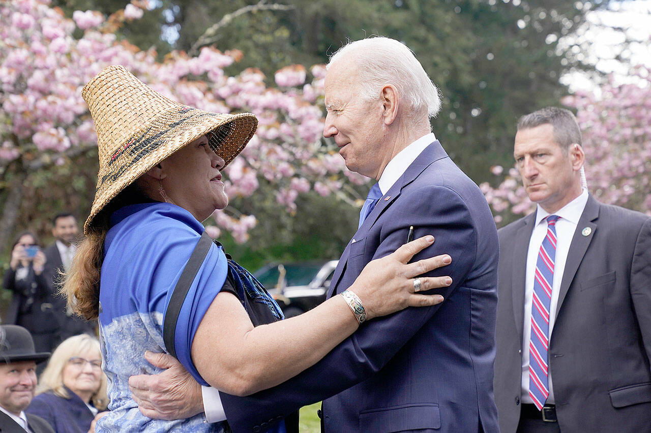 President Joe Biden talks with Teri Gobin, chairwoman of the Tulalip Tribes, after signing an executive order intended to help restore national forests devastated by wildfires, drought and blight, in Seattle on Friday. (Andrew Harnik / Associated Press)