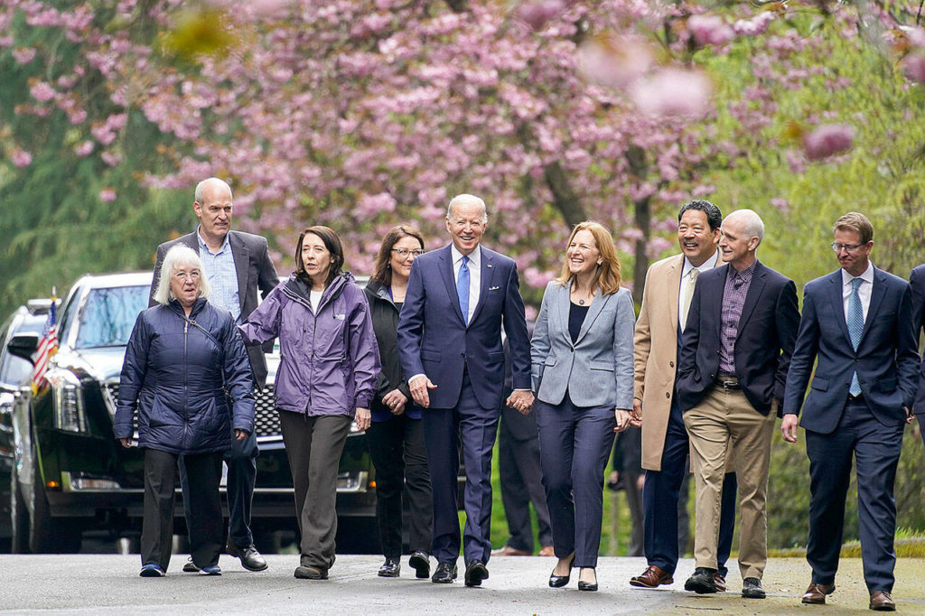 President Joe Biden arrives to speak at Seward Park in Seattle on Friday, flanked by (from left) Sen. Patty Murray, D-Wash., Rep. Rick Larsen, D-Wash., Sen. Maria Cantwell, D-Wash., Rep. Suzan DelBene, D-Wash., Biden, Rep. Kim Schrier, D-Wash., Seattle Mayor Bruce Harrell, Rep. Adam Smith, D-Wash., and Rep. Derek Kilmer, D-Wash. (Andrew Harnik / Associated Press)
