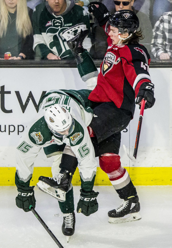 Silvertips’ Ryan Hofer and Giants’ Mazden Leslie get tangled up after a hit during the playoff match up against the Vancouver Giants on Saturday, April 23, 2022 in Everett, Washington. (Olivia Vanni / The Herald)
