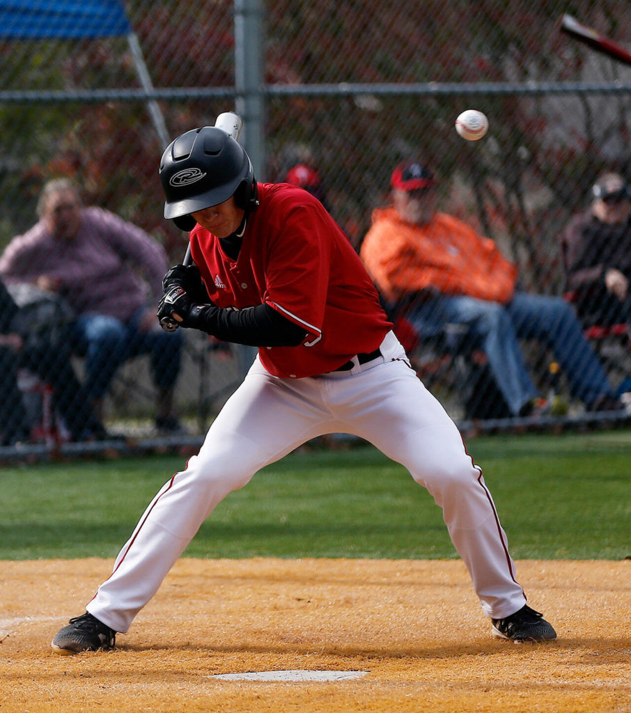 Archbishop Murphy’s Matt Overholt gets hit in the head with a pitch against Stanwood Thursday, April 28, 2022, at Archbishop Murphy High School in Everett, Washington. (Ryan Berry / The Herald)
