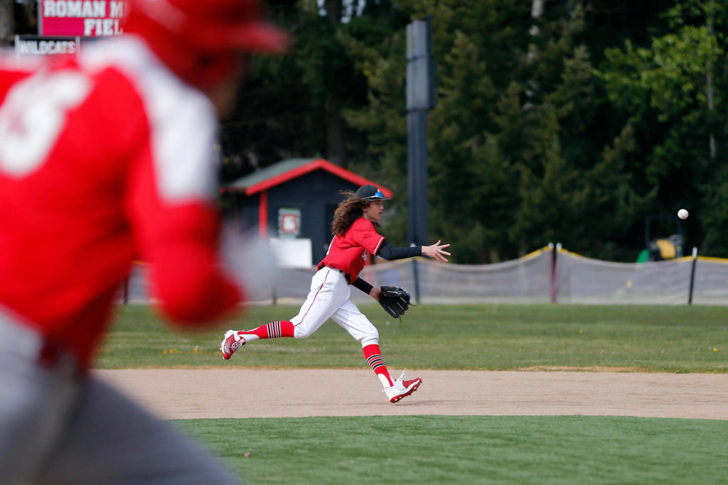 Archbishop Murphy’s Reese Logsdon tries to turn a double play against Stanwood Thursday, April 28, 2022, at Archbishop Murphy High School in Everett, Washington. (Ryan Berry / The Herald)
