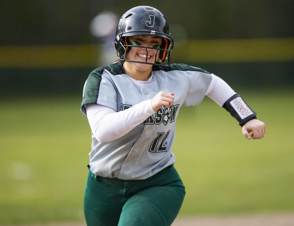 Jackson’s Kaila Zellmer smiles while rounding third base after hitting a home run during the game against Glacier Peak on Thursday, April 28, 2022 in Everett, Washington. (Olivia Vanni / The Herald)
