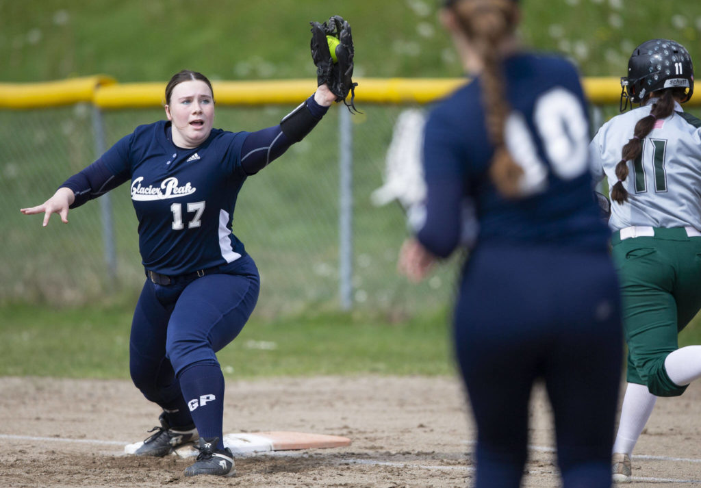 Glacier Peak’s Natalie Dimitro reaches out to catch the ball for an out at first base during the game against Jackson on Thursday, April 28, 2022 in Everett, Washington. (Olivia Vanni / The Herald)
