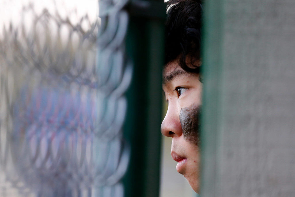 Lynnwood’s Leyon Camantigue watches his teammate bat against Meadowdale Friday, April 29, 2022, at Meadowdale High School in Lynnwood, Washington. (Ryan Berry / The Herald)
