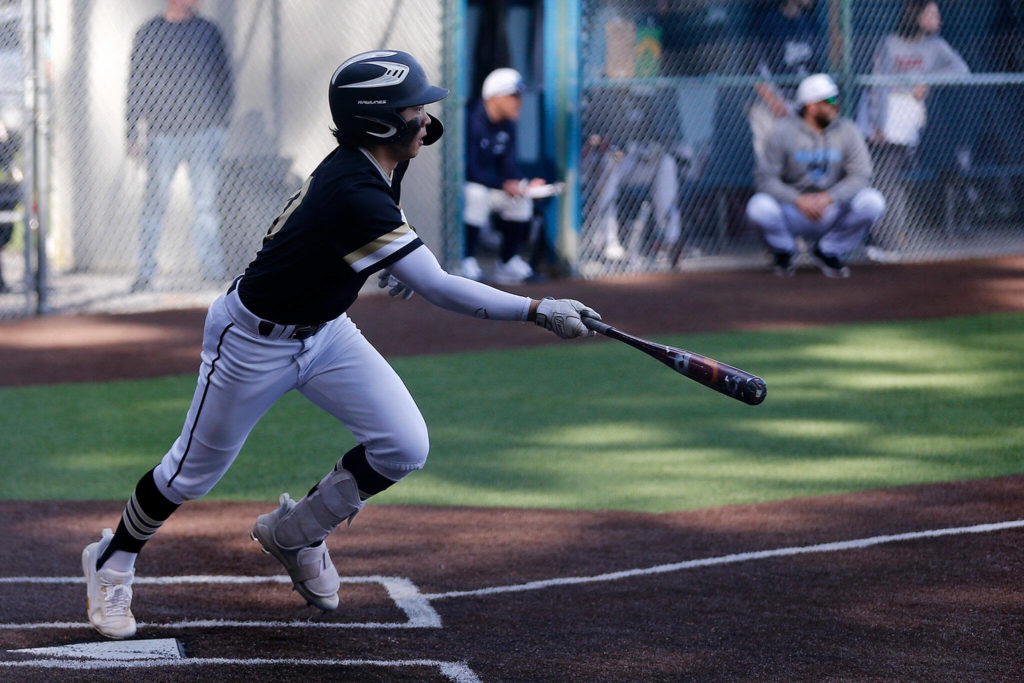 Lynnwood’s Leyon Camantigue runs out of the box after putting the ball in play against Meadowdale Friday, April 29, 2022, at Meadowdale High School in Lynnwood, Washington. (Ryan Berry / The Herald)
