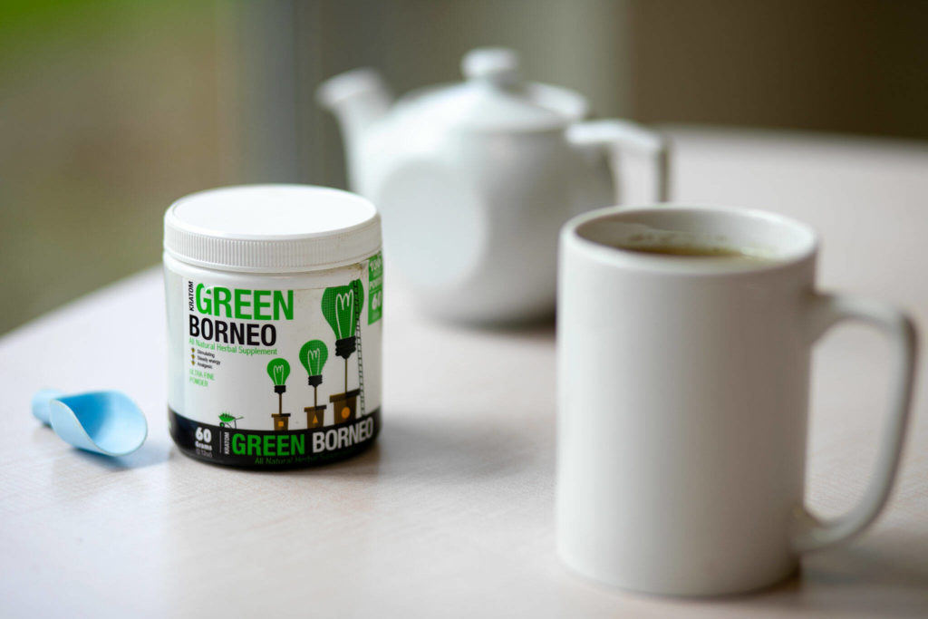 A container of kratom powder sits alongside a mug of prepared tea Friday, May 13, 2022, in Everett, Washington. (Ryan Berry / The Herald)
