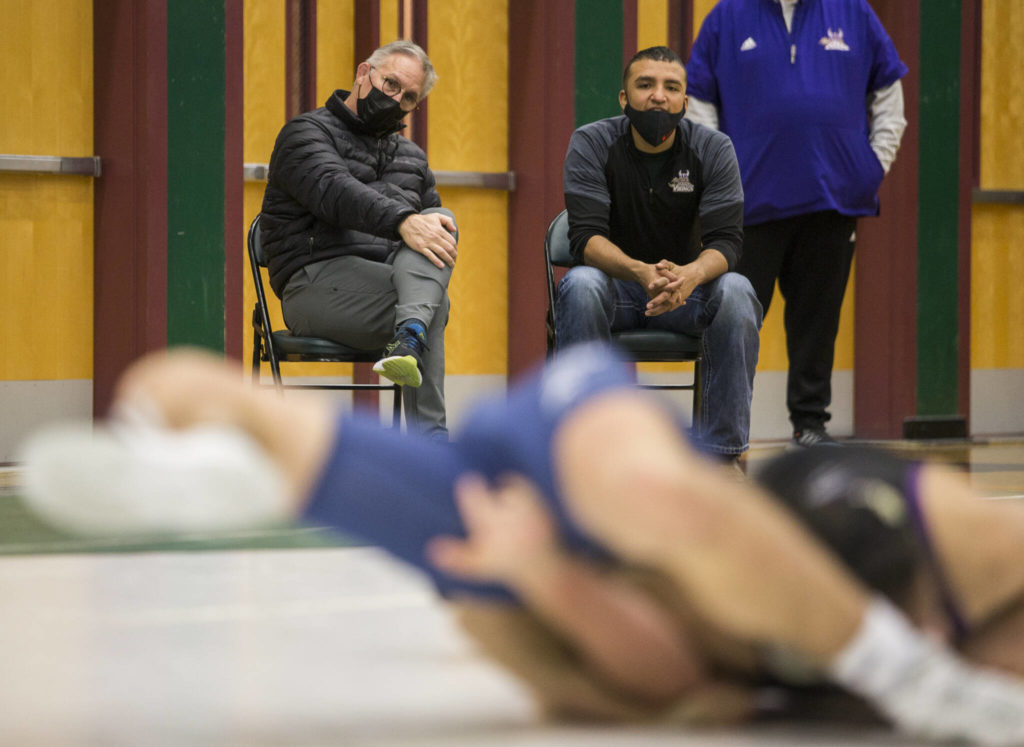 Barnes, left, watches one of his wrestlers compete. (Olivia Vanni / The Herald)
