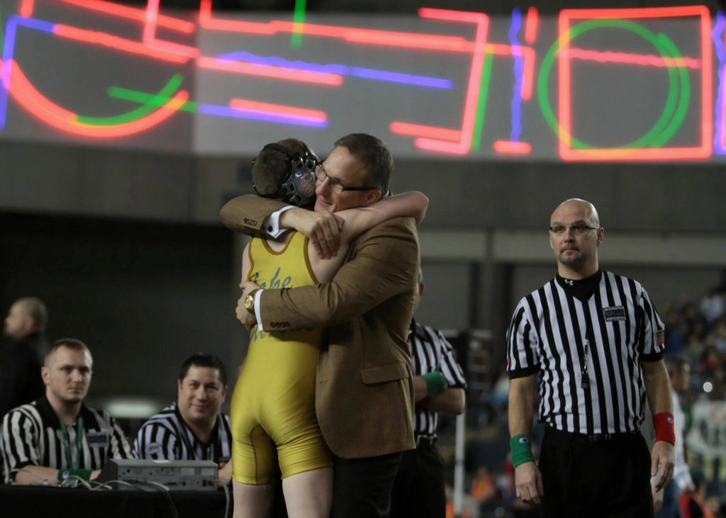 Barnes hugs former Lake Stevens standout Eric Soler after watching him win a state title. (Photo by Al Soler)
