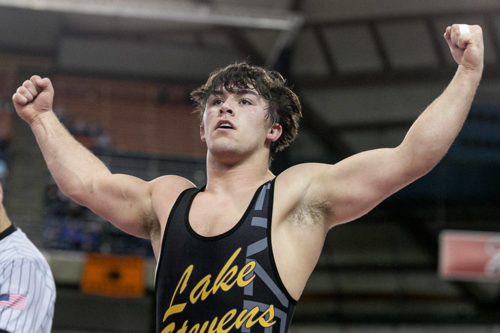 Malachi Lawrence celebrates his second consecutive state title in 2018. He was one of 24 wrestlers to win at least one individual state title under Barnes. (Kevin Clark / The Daily Herald)
