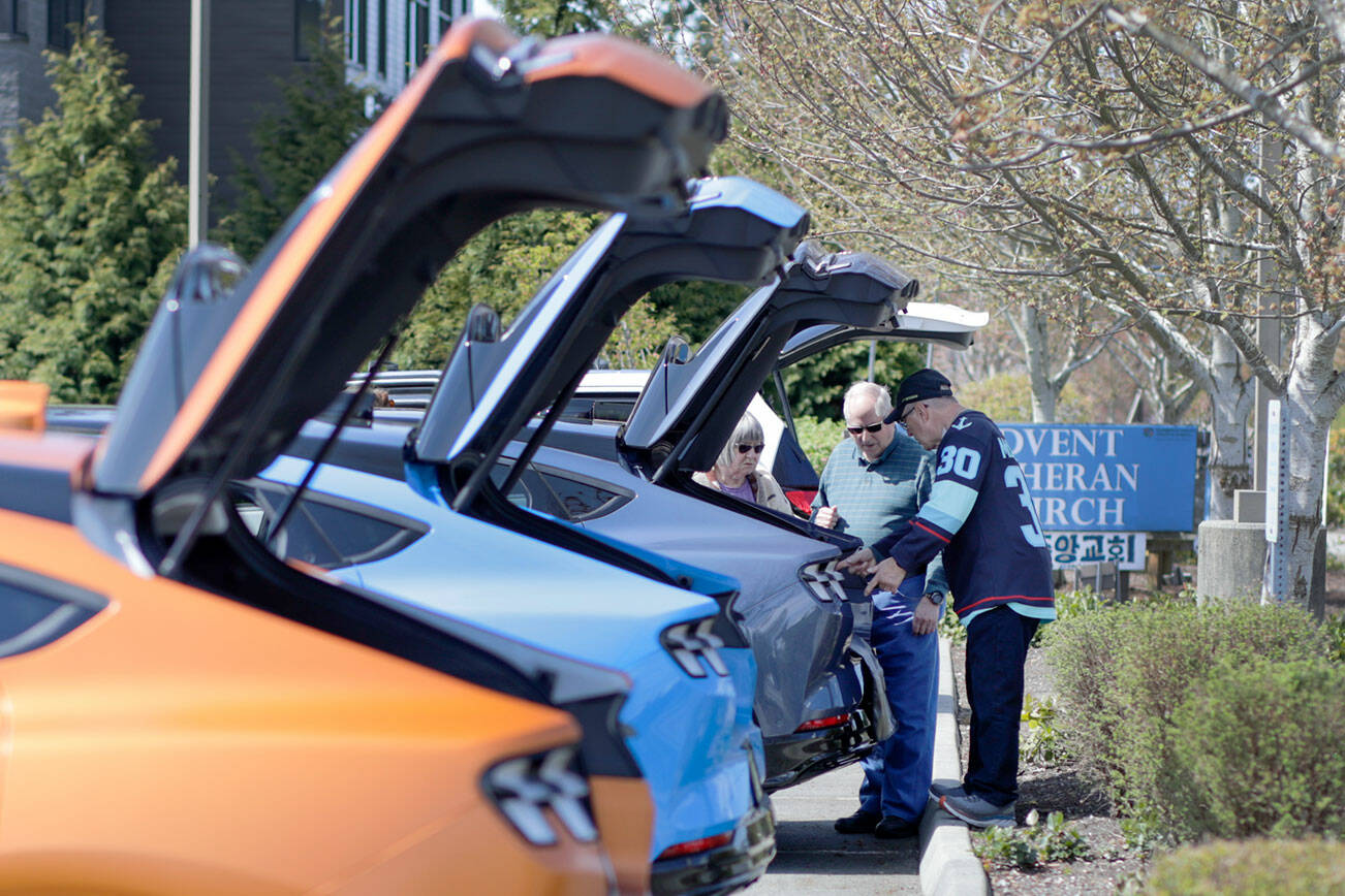 Electric Ford Mustangs are lined up for viewing Saturday afternoon during Drive Electric Earth Day in the Everett, Washington on April 23, 2022. (Kevin Clark / The Herald)