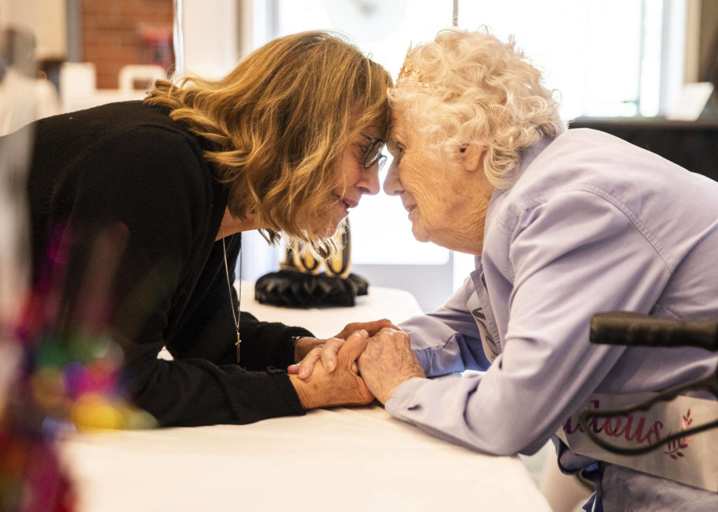 Beverly LaBruyere has a moment with Ferne Ullestad at the party. (Olivia Vanni / The Herald)
