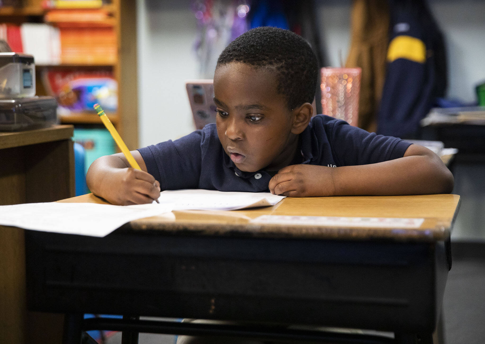 Otis Mugabo works through addition problems during his kindergarten class at Greater Trinity Academy on May 3 in Everett. (Olivia Vanni / The Herald)