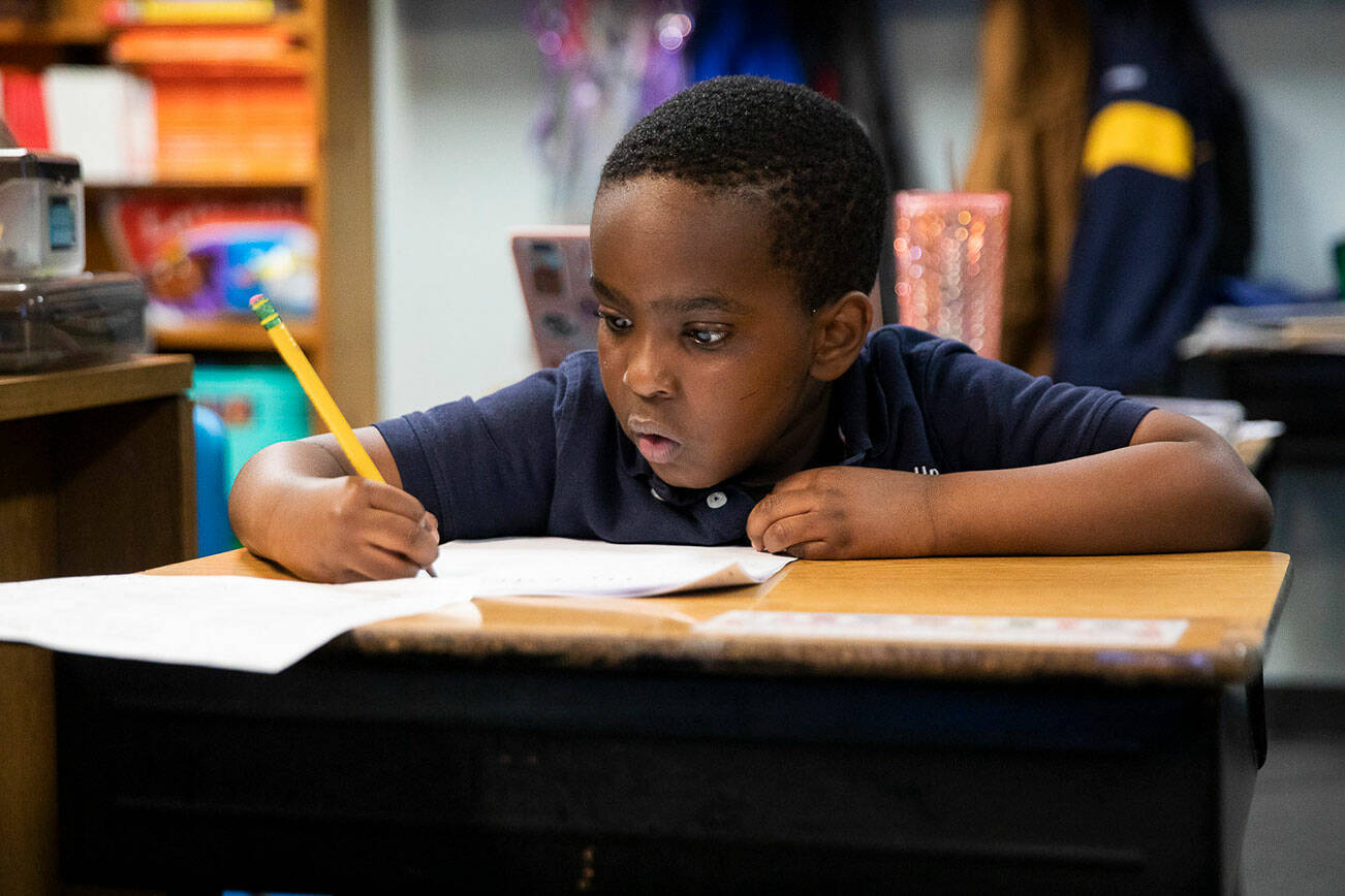 Otis Mugabo works through addition problems during his kindergarten class at Greater Trinity Academy  on Tuesday, May 3, 2022 in Everett, Washington. (Olivia Vanni / The Herald)