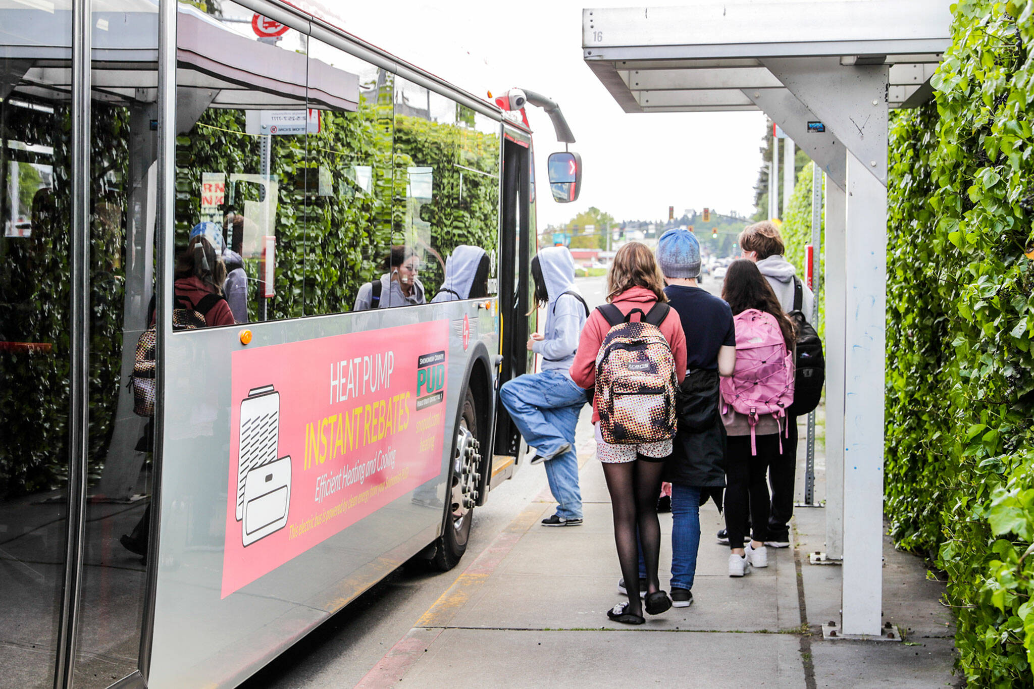 Students board a bus Wednesday near Sequoia High School in Everett. The city’s transit agency is proposing to let riders 18 and under ride without paying a fare, a provision of Move Ahead Washington legislation. (Kevin Clark / The Herald)