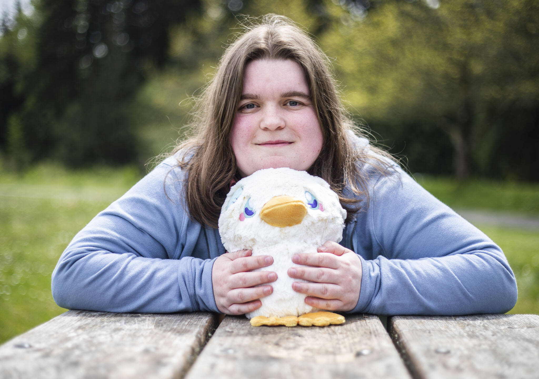 Bailey Hendrickson, owner of Adorable Potato Creations, with one of her specialty plushies called Totally Normal Non Suspicious Duck. (Olivia Vanni / The Herald)