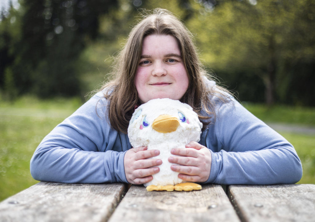 Bailey Hendrickson, owner of Adorable Potato Creations, with one of her specialty plushies called Totally Normal Non Suspicious Duck. (Olivia Vanni / The Herald)
