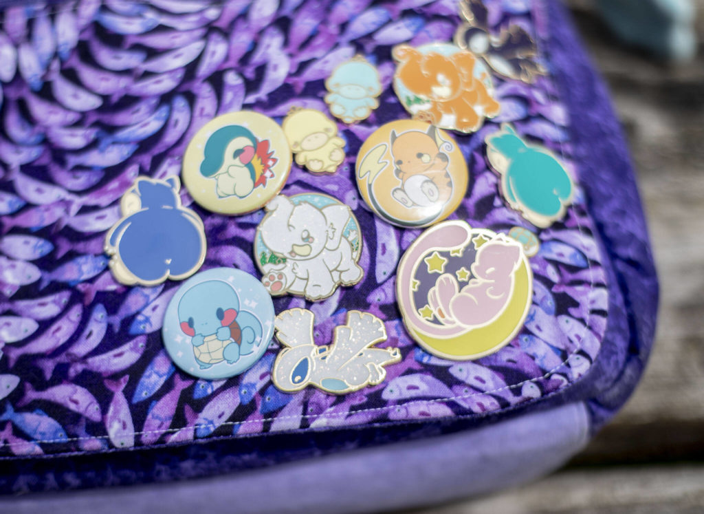 A collection of enamel and button pins available from Adorable Potato Creations. (Olivia Vanni / The Herald)
