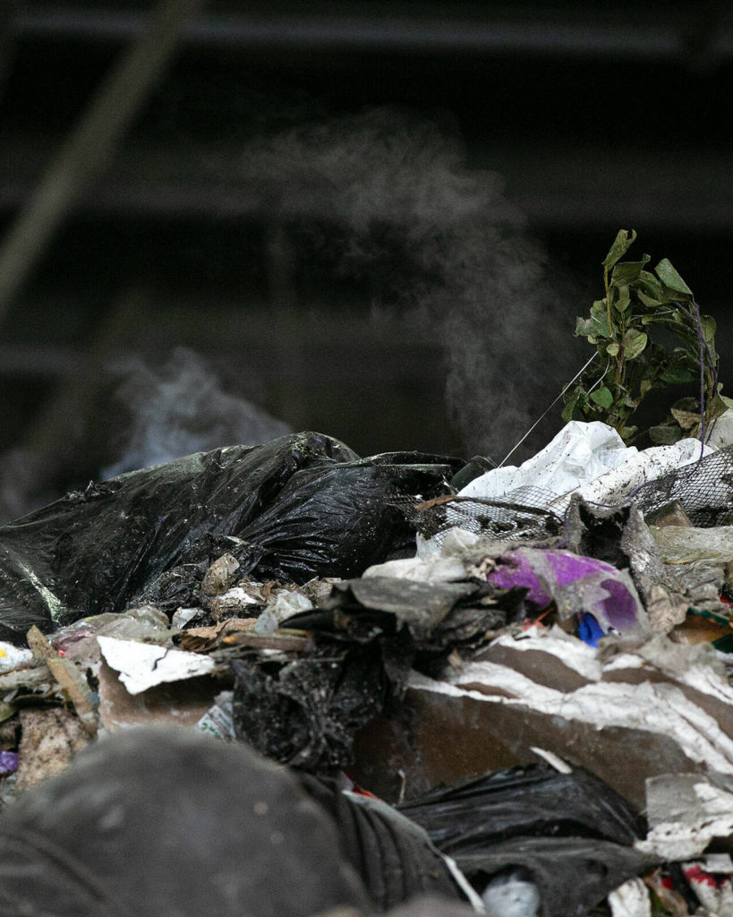 Steam rises from the top of a gigantic pile of garbage Friday at the Airport Road Recycling and Transfer Station in Everett. The facility is on 24/7 fire watch due to the increased chances of the enormous garbage pile spontaneously combusting. (Ryan Berry / The Herald)
