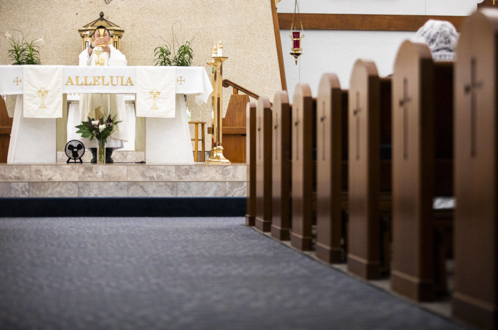 Father Tuan Nguyen holds morning mass at Immaculate Conception Church on Wednesday in Everett. It will become home to the new merged parish, Our Lady of Hope. (Olivia Vanni / The Herald)
