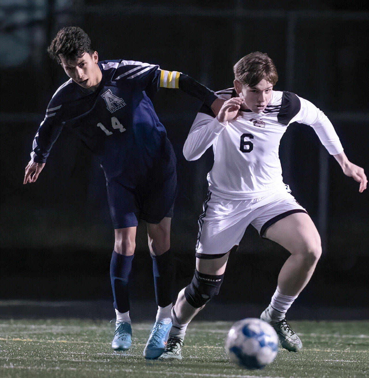 Monroe’s Owen Skurdal chases down the ball during a game against Arlington on March 18 in Arlington. (Kevin Clark / The Herald)