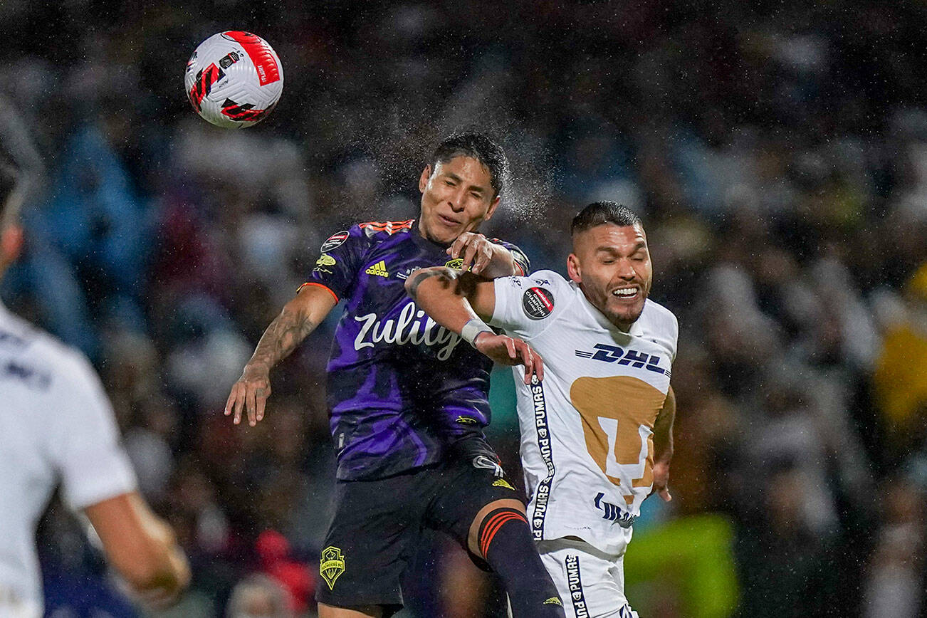 Nicolas Freire of Mexico's Pumas, right, and Raul Ruidíaz of United States' Seattle Sounders fight for the ball during the first leg of the CONCACAF Champions League soccer final, in Mexico City, Wednesday, April 27, 2022. (AP Photo/Marco Ugarte)