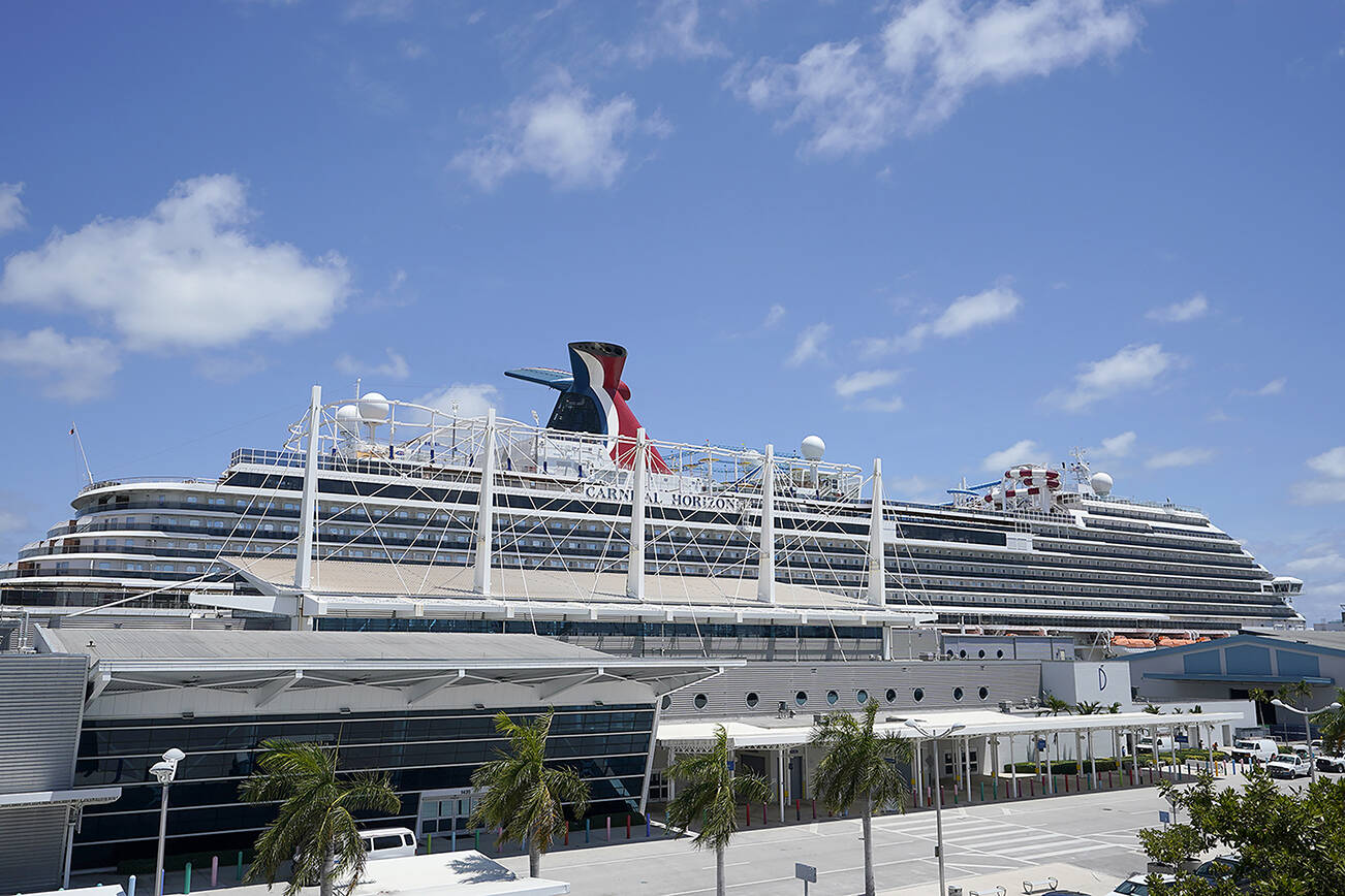 Carnival Cruise Line's Carnival Horizon cruise ship is shown docked at PortMiami, Friday, April 9, 2021, in Miami.  The U.S. Centers for Disease Control and Prevention is investigating more cruise ships due to new COVID-19 cases aboard. The agency says 88 vessels are now either under investigation or observation, but it does not specify how many cases have been reported. (AP Photo/Wilfredo Lee)