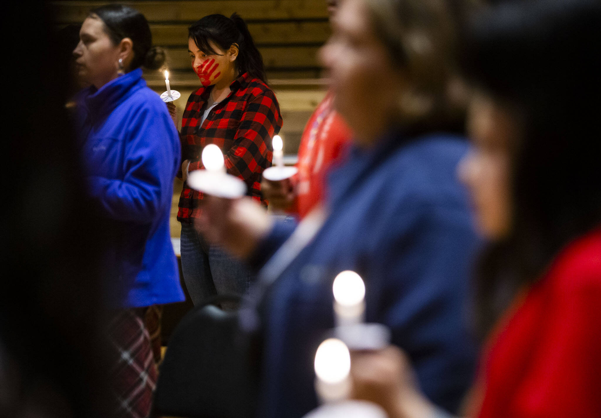 Taleen Enick, 15, holds a candle during a MMIW candlelight vigil at the Tulalip Gathering Hall on Thursday in Tulalip. (Olivia Vanni / The Herald)