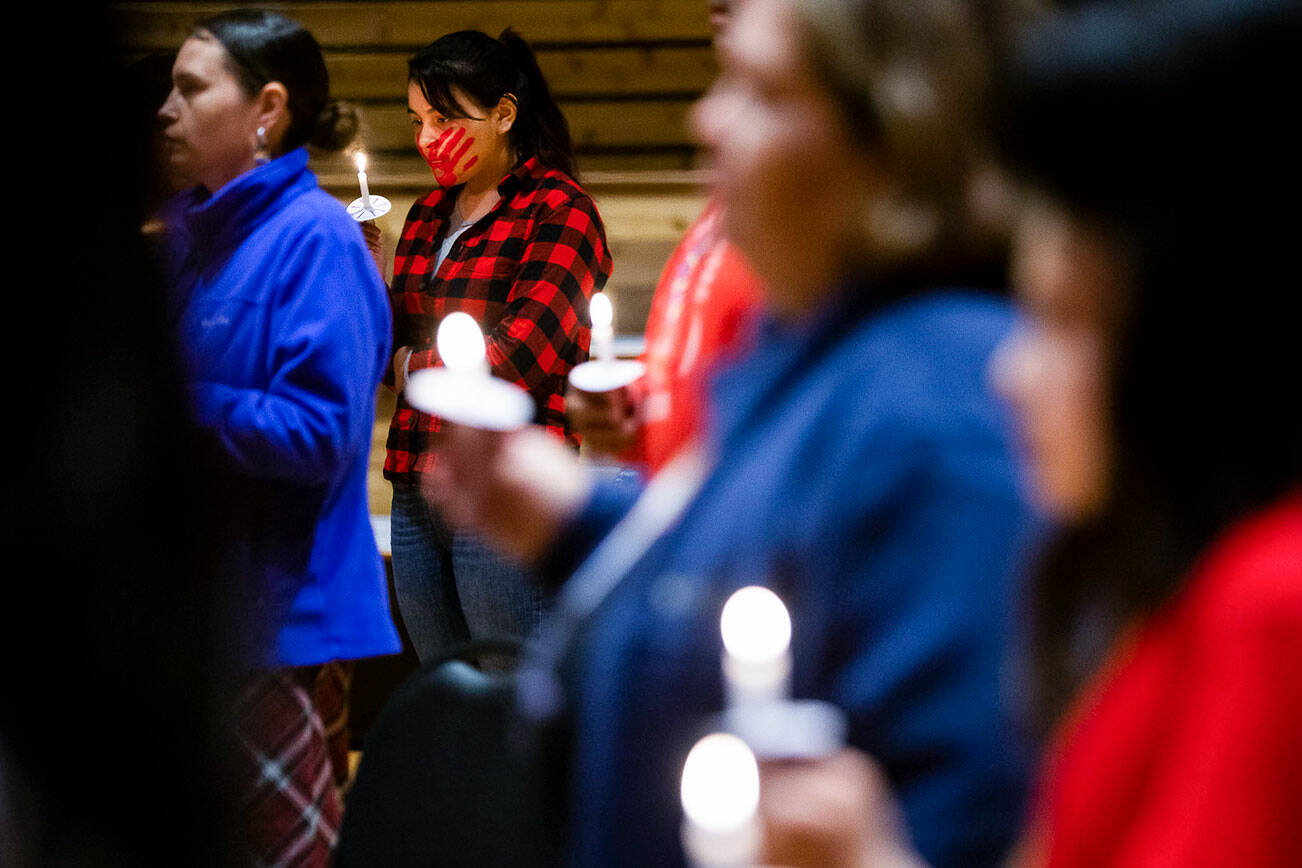 Taleen Enick, 15, holds a candle during a MMIW candlelight vigil at the Tulalip Gathering Hall on Thursday, May 5, 2022, in Tulalip, Washington. (Olivia Vanni / The Herald)