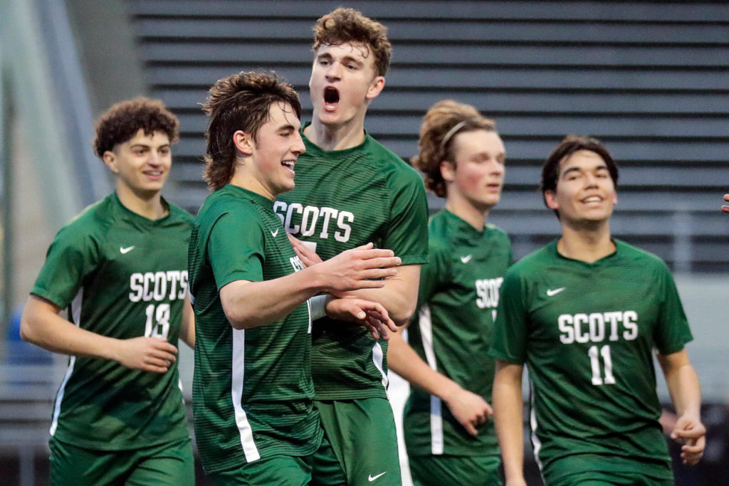 Shorecrest senior Mason Dougherty, front, celebrates a goal with his teammates. The Scots went a perfect 16-0 in the regular season, while outscoring their opponents 60-5. (Kevin Clark / The Herald)
