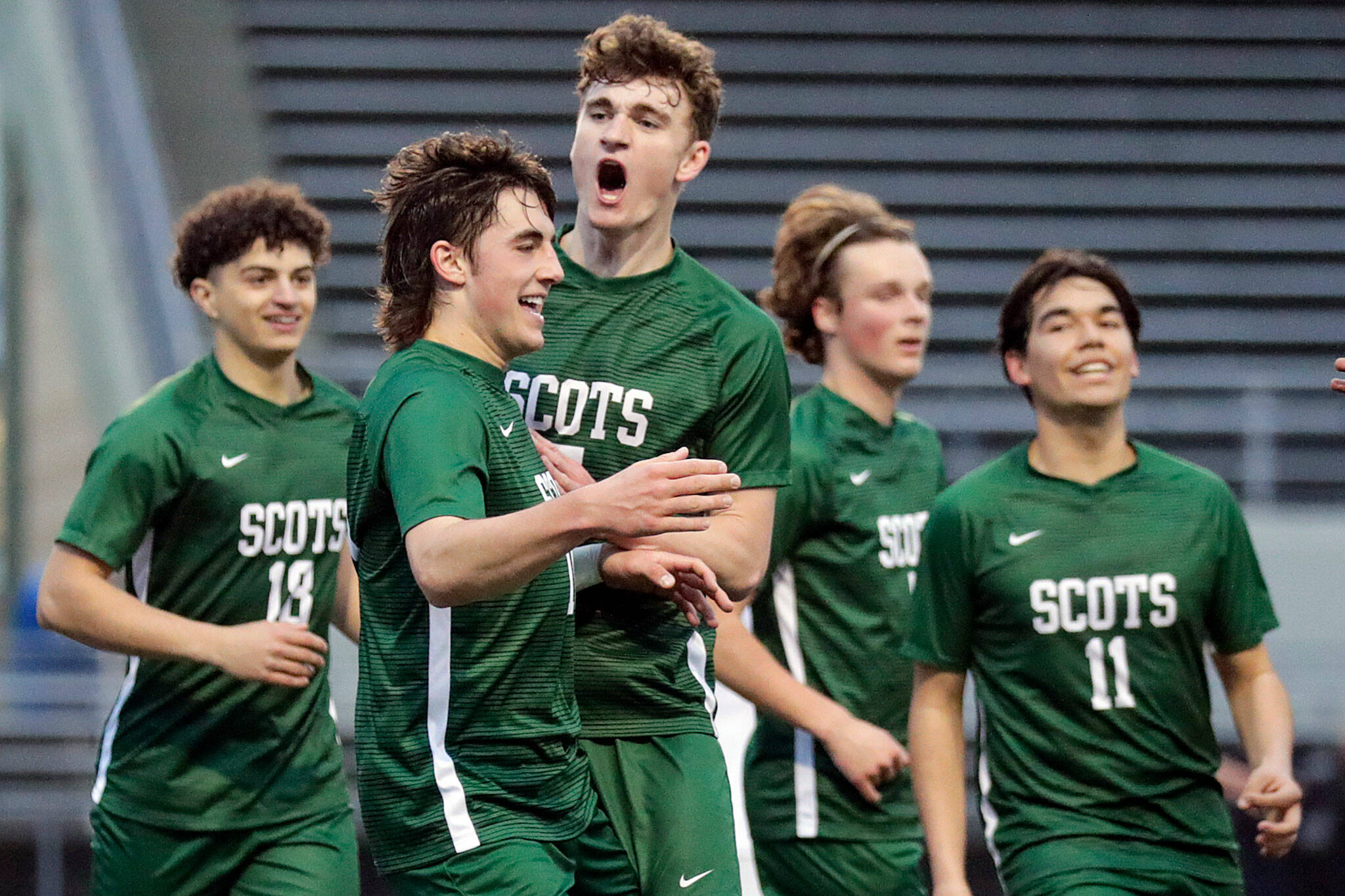 Shorecrest senior Mason Dougherty, front, celebrates a goal with his teammates. The Scots went a perfect 16-0 in the regular season, while outscoring their opponents 60-5. (Kevin Clark / The Herald)