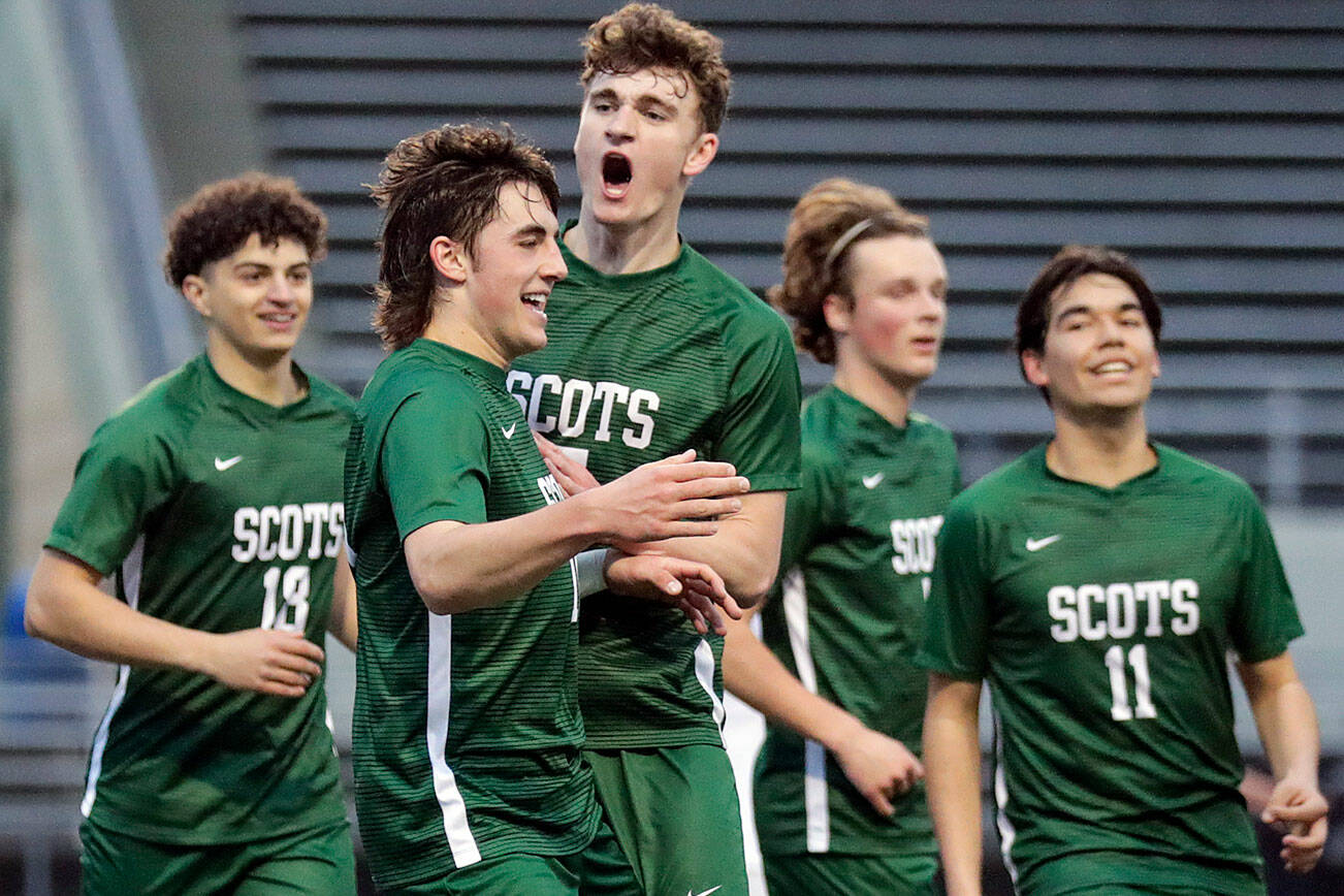 Shorecrest’s Mason Dougherty, front, is celebrated for a goal against Edmonds-Woodway High School Tuesday evening at Shoreline Stadium in Shoreline, Washington on May 3, 2022. (Kevin Clark / The Herald)