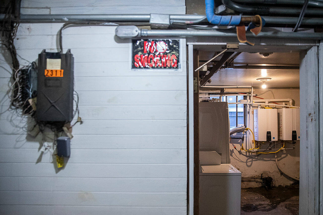 Water heaters that are not up to code are visible from the hallway on Wednesday, May 11, 2022 in Everett, Washington. (Olivia Vanni / The Herald)