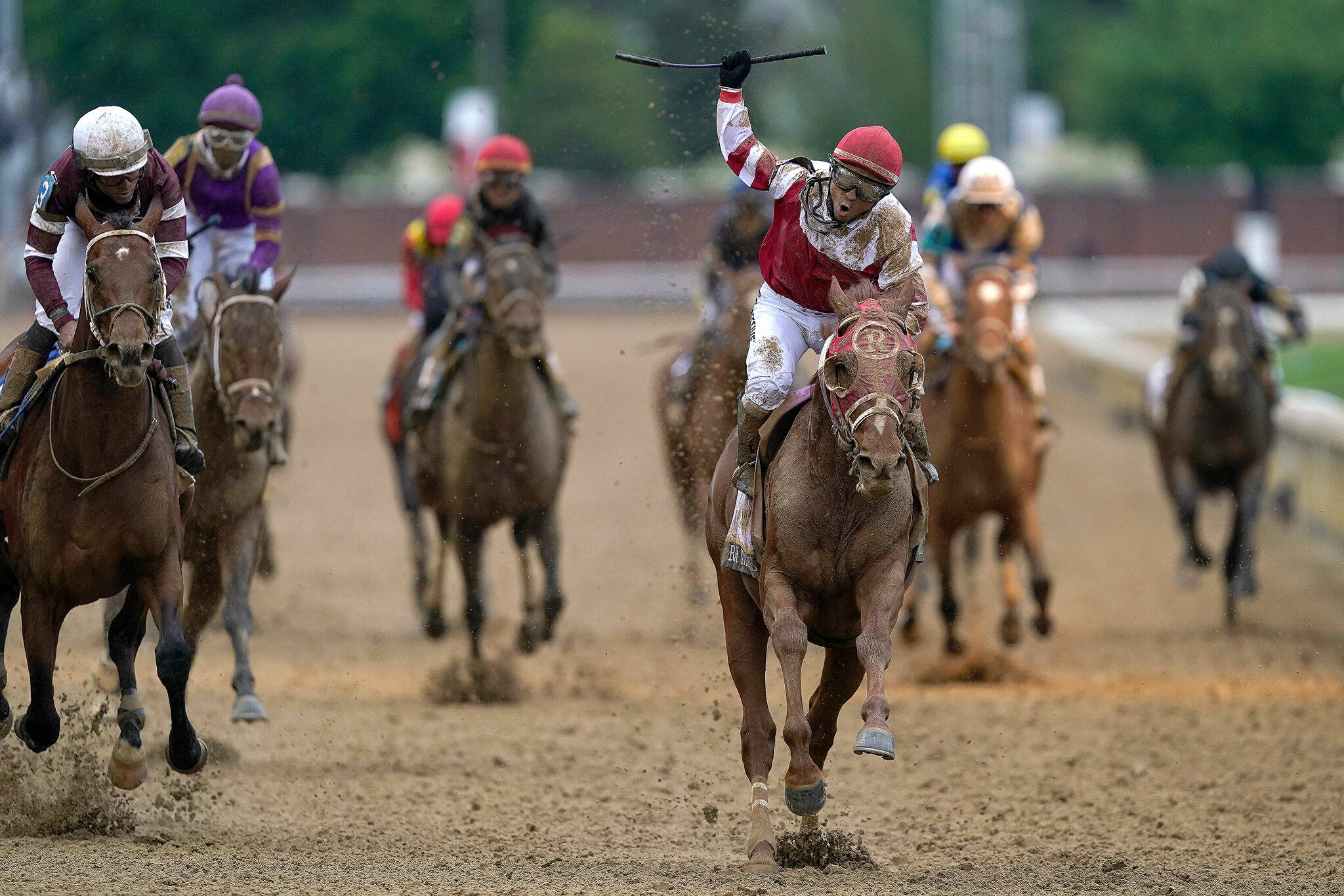 Sonny Leon celebrates after riding Rich Strike past the finish line to win the 148th running of the Kentucky Derby on Saturday at Churchill Downs in Louisville, Ky. (AP Photo/Charlie Neibergall)