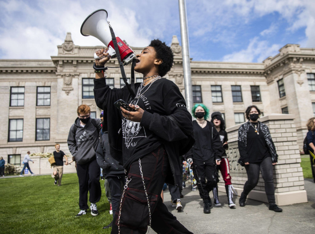 Everett High School student Soren Dellaguardia leads a walkout from the high school to North Middle School on Monday in Everett. (Olivia Vanni / The Herald)
