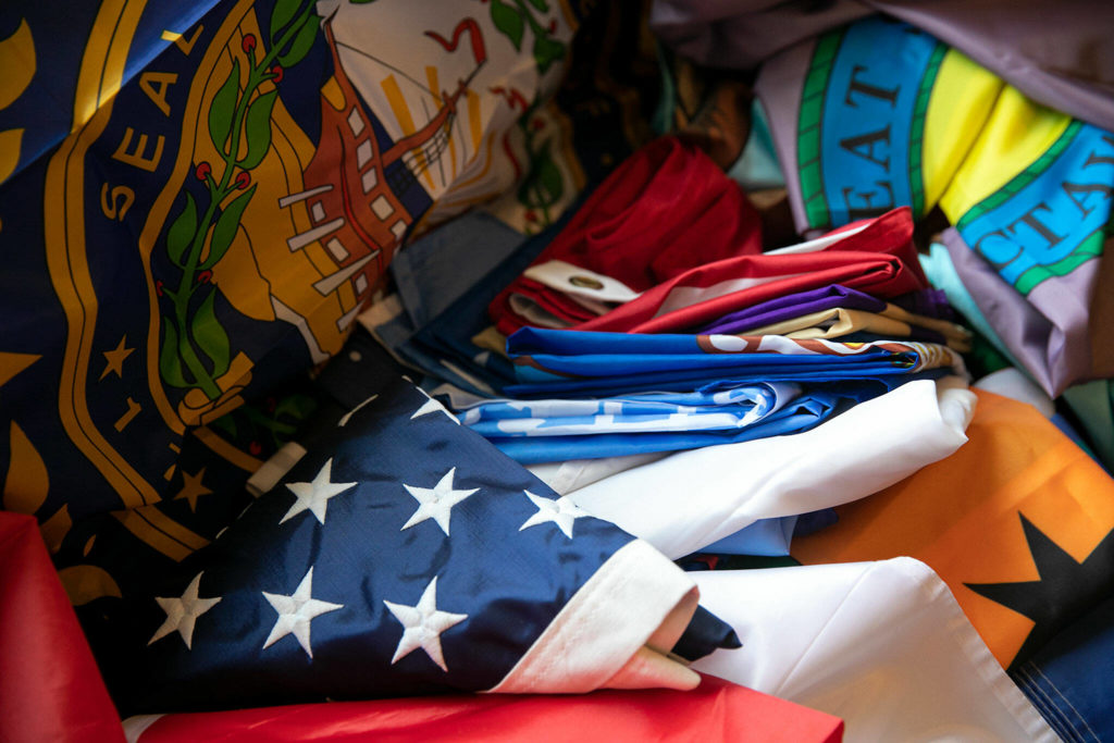 An American flag is seen among dozens of other flags at Melissa Batson’s home in Monroe. The two American flags Batson owns were her first two flag purchases. (Ryan Berry / The Herald)
