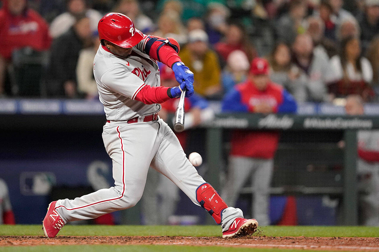 Philadelphia Phillies’ Jean Segura hits into a force out that allowed Nick Castellanos to score from third during the fifth inning of a game against the Seattle Mariners on Monday in Seattle. (AP Photo/Ted S. Warren)