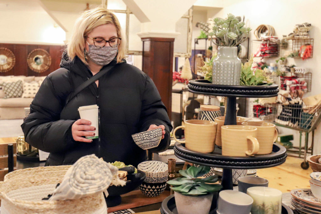 Heather Mimms looks over Lamb Co. merchandise. (Kevin Clark / The Herald)
