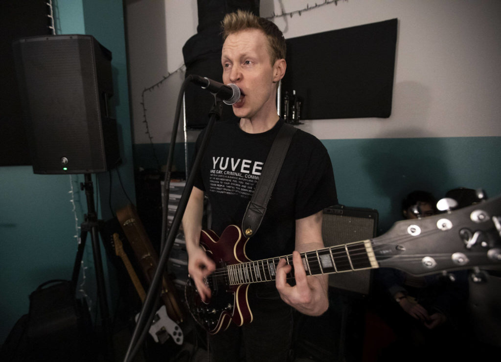 Bad Optics guitarist Christian Smith sings while the band practices May 17 in Everett. (Olivia Vanni / The Herald)

