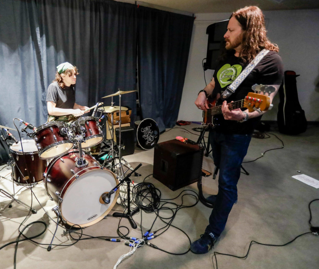 Cyra Wirth (left) and Harry Wirth of The Little Lies rehearse in Everett on May 16. (Kevin Clark / The Herald)
