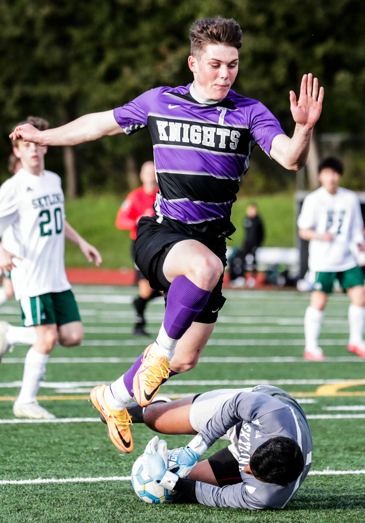 Kamiak’s Koll Pehlivanian leaps over a shot stopped by Skyline’s Arnav Murudkar in the first half of a winner-to-state bi-district semfinal game Tuesday evening at Kamiak High School in Mukilteo. (Kevin Clark / The Herald)