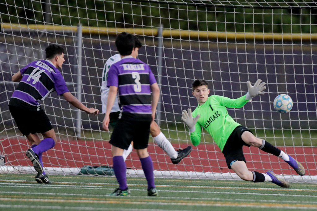 Skyline’s Eyal Shechtman makes a goal past Kamiak’s Weston Joyner during a winner-to-state bi-district semfinal game Tuesday evening at Kamiak High School in Mukilteo. (Kevin Clark / The Herald)
