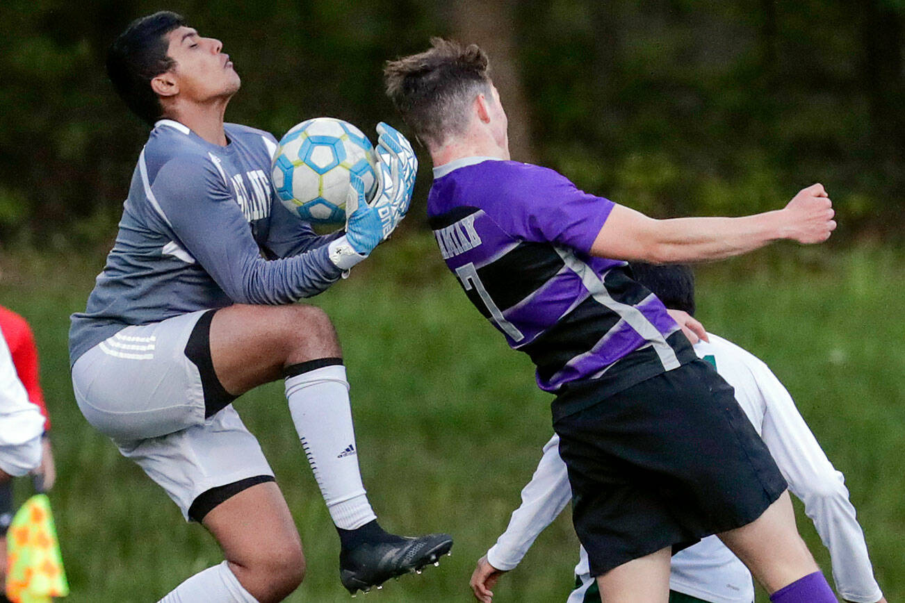 Skyline’s Arnav Murudkar gather a shot with Kamiak’s Koll Pehlivanian attempting a header Tuesday afternoon at Kamiak High School in Mukilteo, Washington on May 10, 2022.  (Kevin Clark / The Herald)