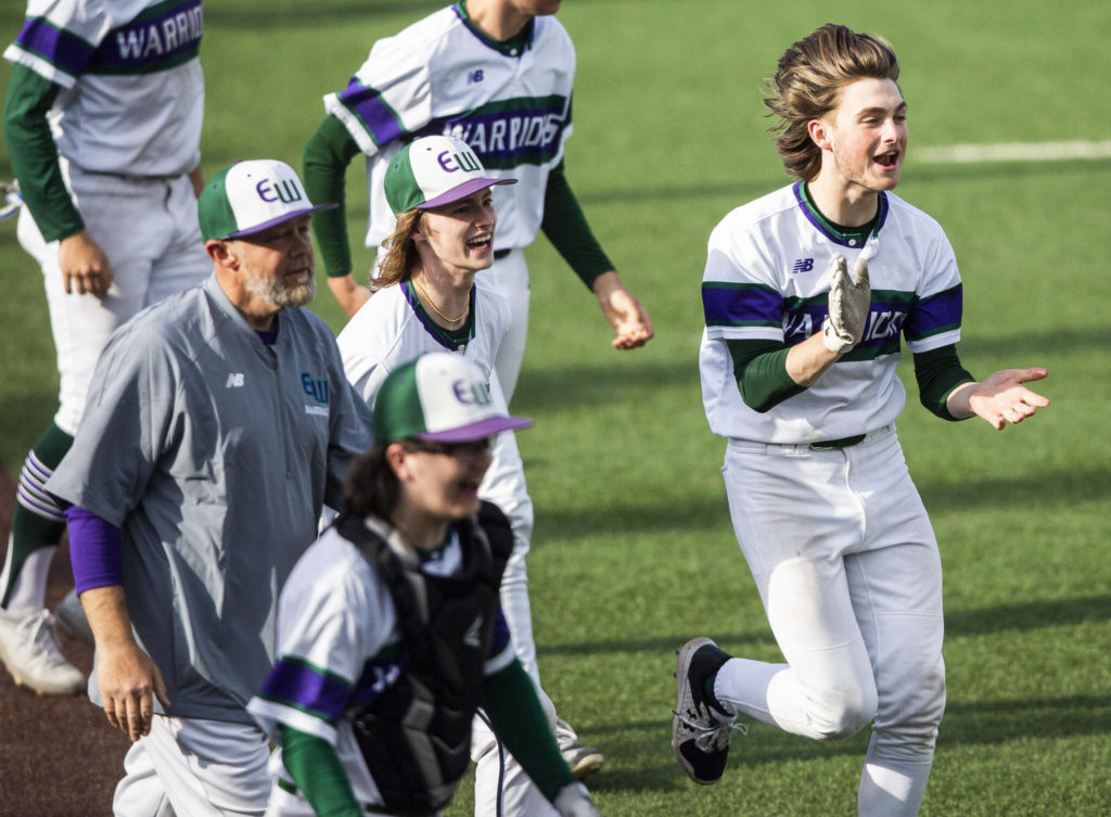 Edmonds-Woodway players celebrate their 11-1 mercy-rule win over Mountlake Terrace in a Class 3A District 1 Tournament semifinal Tuesday afternoon. The victory clinched the Warriors’ fourth consecutive state berth. (Olivia Vanni / The Herald)
