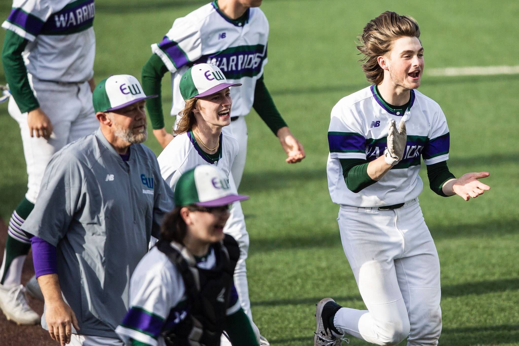 Edmonds-Woodway players celebrate their 11-1 mercy-rule win over Mountlake Terrace in a Class 3A District 1 Tournament semifinal Tuesday afternoon at Funko Field. The victory clinched the Warriors’ fourth consecutive state berth. (Olivia Vanni / The Herald)