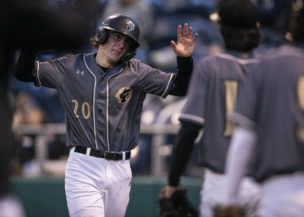 Lynnwood’s Mason Lane high fives his teammates after scoring during the district semifinal game at Funko Field on Tuesday in Everett. (Olivia Vanni / The Herald)
