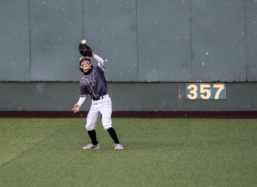 Lynnwood’s Jacob McClellan makes a catch in the outfield during the district semifinal game at Funko Field on Tuesday in Everett. (Olivia Vanni / The Herald)
