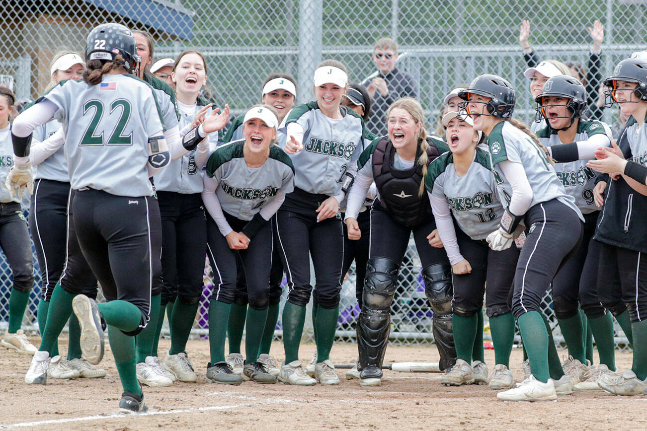 Jackson’s Allie Thomsen is greeted at home for the two run game tying homer against Glacier Peak Wednesday afternoon at Glacier Peak High School in Snohomish, Washington on May 11, 2022.  The Timberwolves defeated the Grizzles 5-3 in extra innings to claim the league title. (Kevin Clark / The Herald)