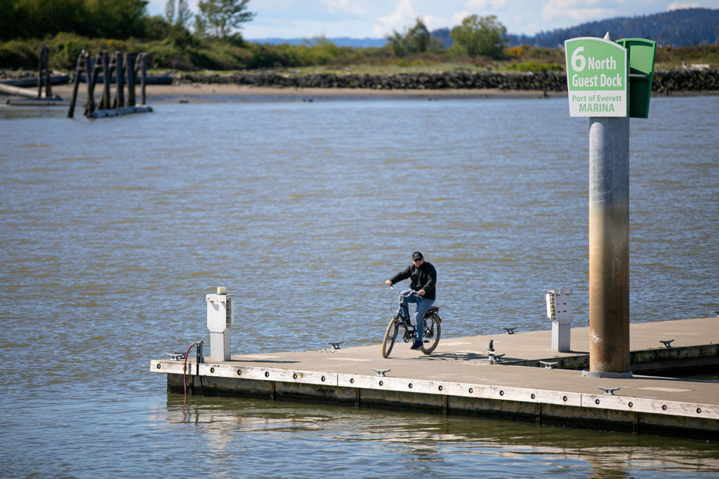 A man rides his bicycle on the dock at the Port of Everett on May 8 in Everett. (Ryan Berry / The Herald)
